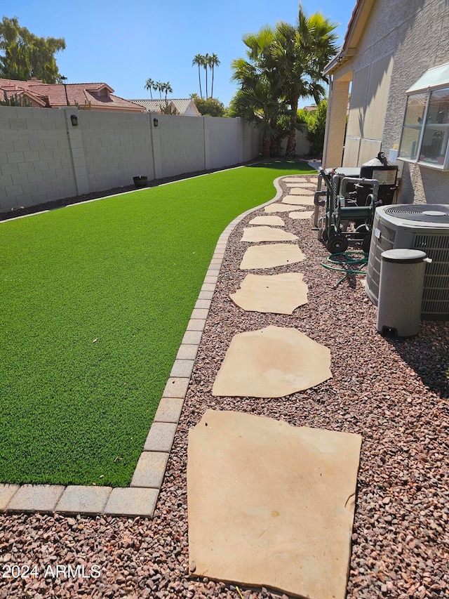 view of yard with a patio and central air condition unit