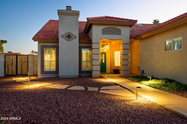 view of back house at dusk