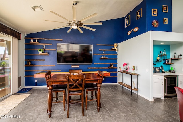 dining space featuring wine cooler, ceiling fan, indoor bar, and lofted ceiling