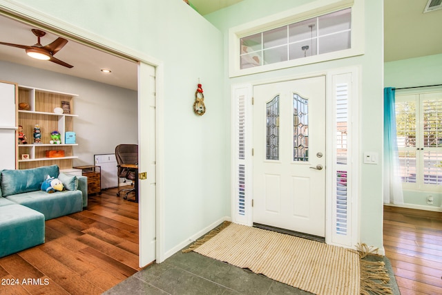 entryway with ceiling fan and dark wood-type flooring