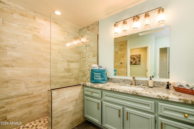 bathroom featuring vanity and a tile shower