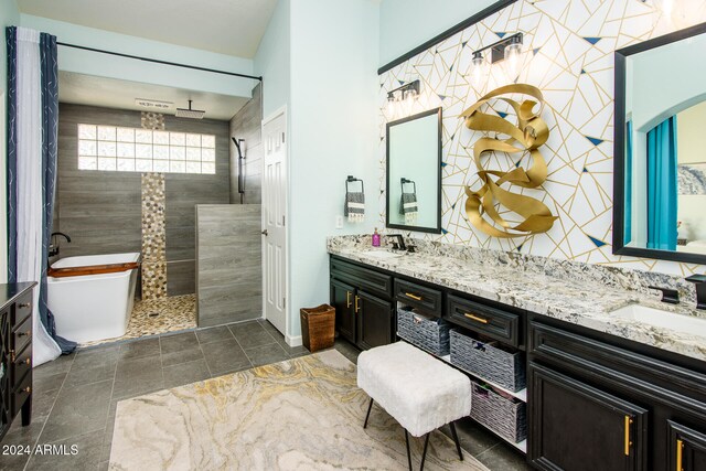 bathroom featuring vanity and independent shower and bath