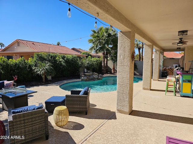 view of pool with ceiling fan and a patio