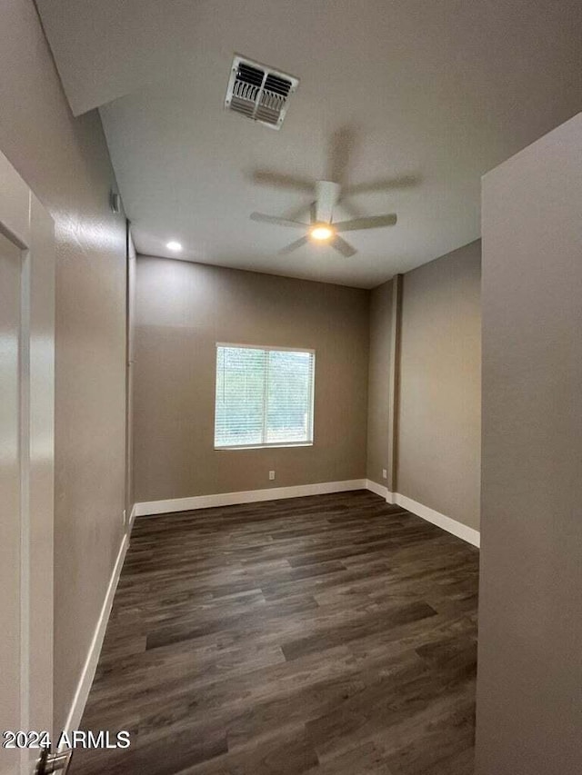 spare room featuring visible vents, baseboards, and wood finished floors