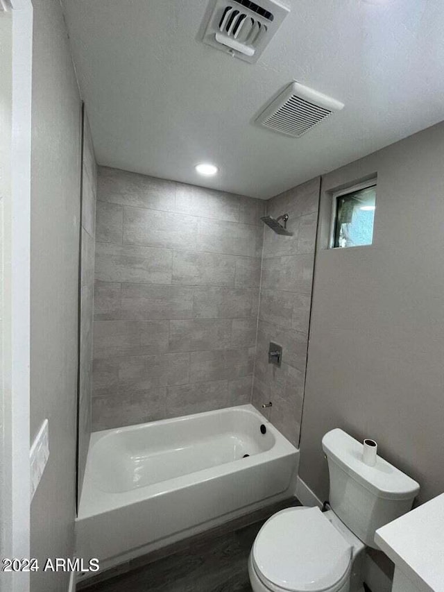 bathroom featuring shower / washtub combination, visible vents, vanity, and toilet