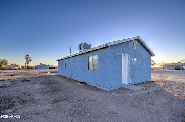 back house at dusk with cooling unit