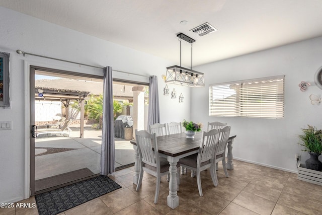 dining space featuring tile patterned flooring, visible vents, and baseboards