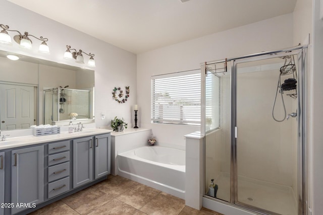 bathroom featuring a garden tub, a sink, a shower stall, and double vanity