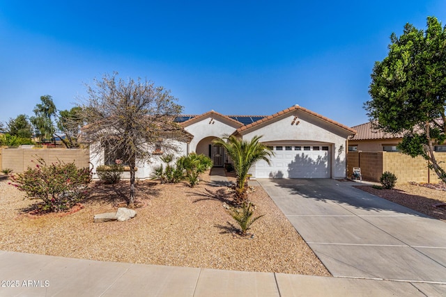 mediterranean / spanish home with driveway, a tiled roof, an attached garage, fence, and stucco siding