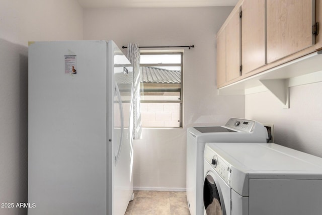 washroom with washing machine and dryer and cabinet space