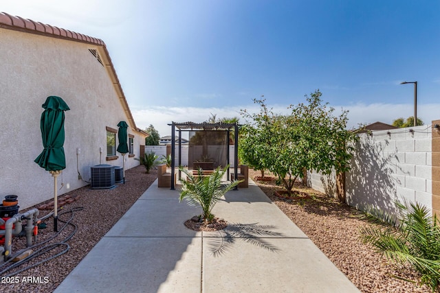 view of patio featuring a fenced backyard and central AC