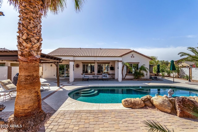 pool with ceiling fan and a patio