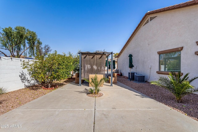 exterior space with central AC unit, fence, and a pergola