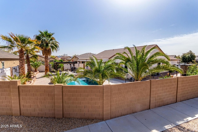 view of front of home featuring a tile roof, a residential view, fence, and stucco siding