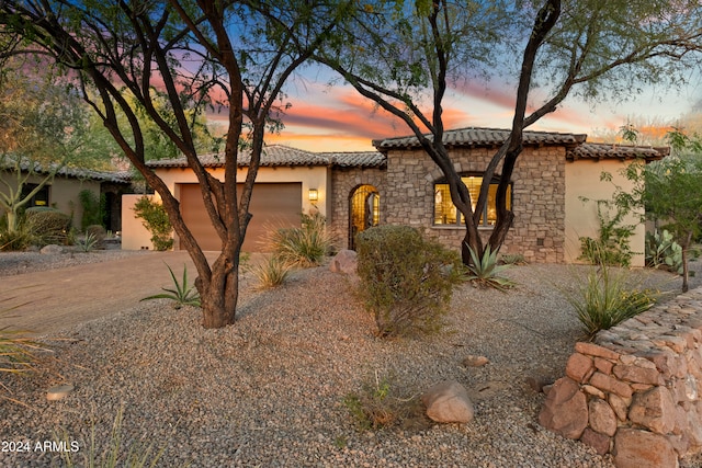 mediterranean / spanish-style house featuring a garage