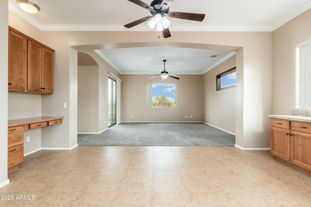 4253 N Yates Ave, Prescott Valley, AZ 86314 - unfurnished dining area featuring ceiling fan, light colored carpet, crown molding, baseboards, and arched walkways