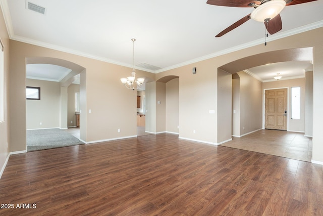 4253 N Yates Ave, Prescott Valley, AZ 86314 - unfurnished living room featuring healthy amount of natural light, wood finished floors, arched walkways, and crown molding