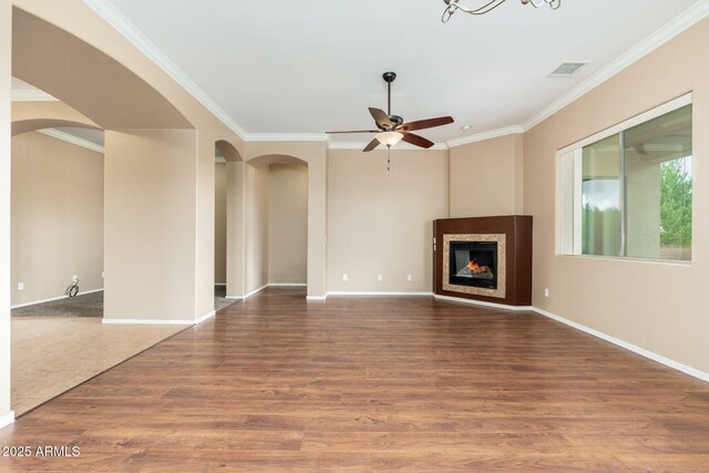 4253 N Yates Ave, Prescott Valley, AZ 86314 - unfurnished living room with arched walkways, crown molding, ceiling fan, wood finished floors, and baseboards