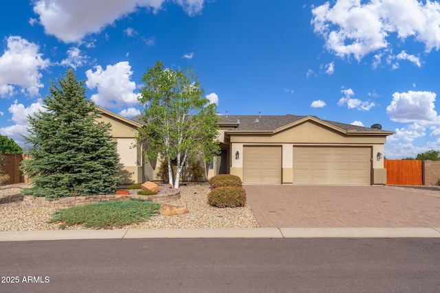 4253 N Yates Ave, Prescott Valley, AZ 86314 - view of front of property featuring stucco siding, decorative driveway, an attached garage, and fence