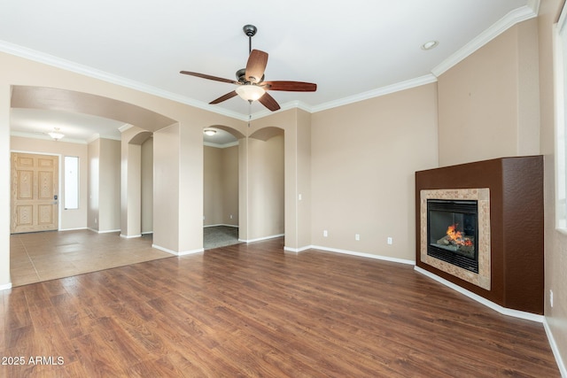 4253 N Yates Ave, Prescott Valley, AZ 86314 - unfurnished living room with crown molding, ceiling fan, wood finished floors, arched walkways, and baseboards