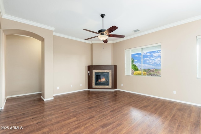 4253 N Yates Ave, Prescott Valley, AZ 86314 - unfurnished living room featuring wood finished floors, crown molding, ceiling fan, arched walkways, and baseboards