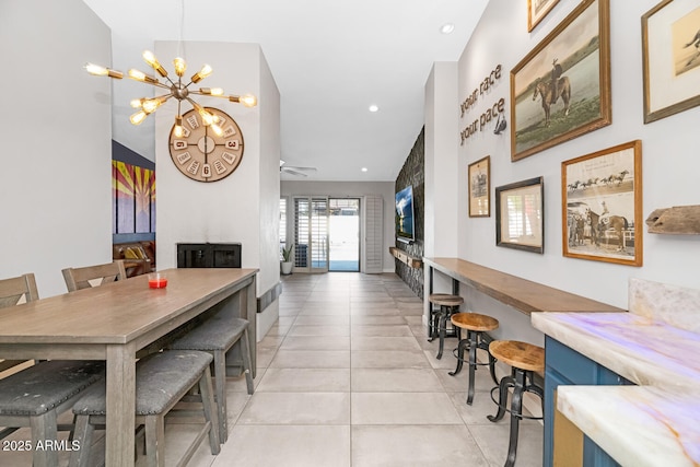 dining room with light tile patterned floors, recessed lighting, and ceiling fan with notable chandelier