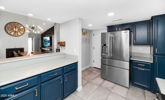 kitchen featuring visible vents, recessed lighting, high end fridge, light countertops, and blue cabinets