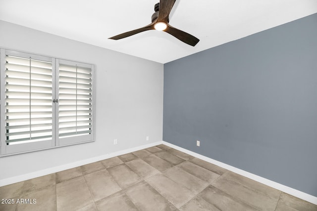 spare room with baseboards and ceiling fan