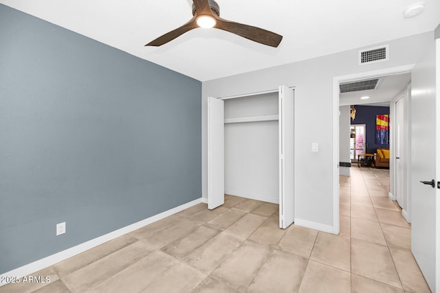 unfurnished bedroom with light tile patterned floors, baseboards, visible vents, and ceiling fan