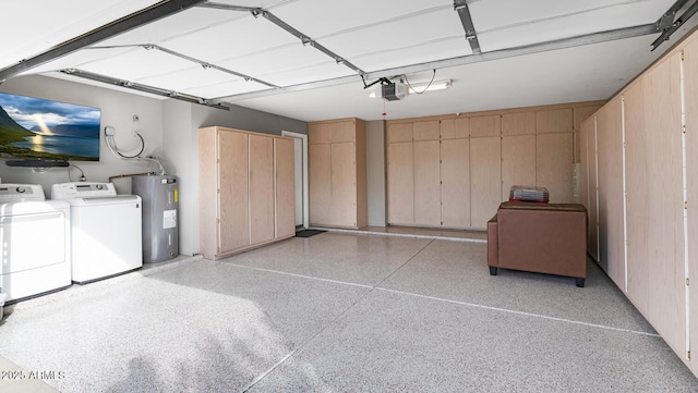 garage with a garage door opener, separate washer and dryer, and electric water heater