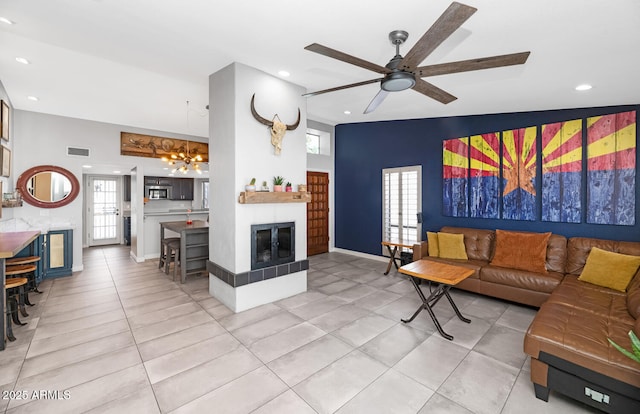 living room featuring light tile patterned floors, visible vents, baseboards, recessed lighting, and ceiling fan with notable chandelier