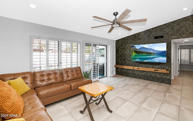 tiled living room with visible vents, a ceiling fan, recessed lighting, an accent wall, and vaulted ceiling