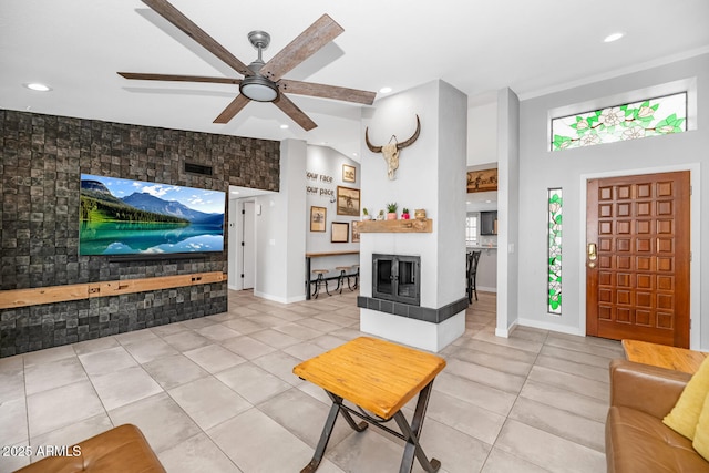 living area featuring a ceiling fan, visible vents, light tile patterned flooring, recessed lighting, and a multi sided fireplace