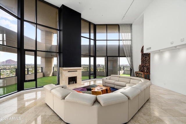 living room with a mountain view, floor to ceiling windows, and a high ceiling