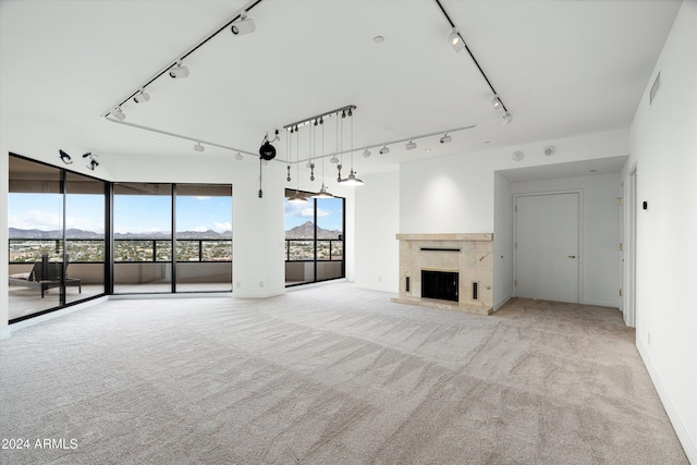 unfurnished living room featuring a tile fireplace and light carpet