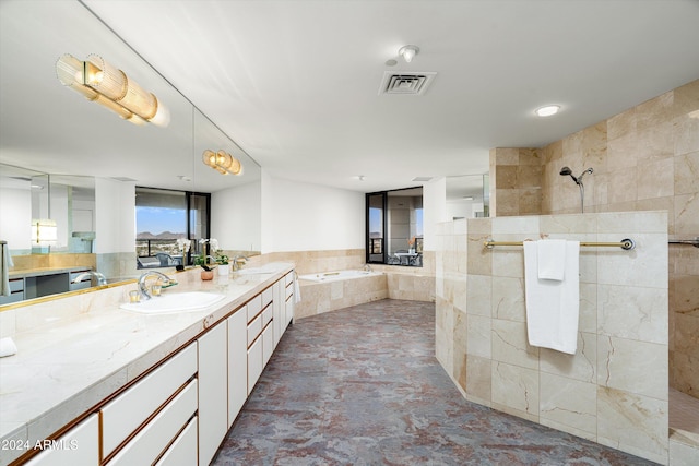 bathroom featuring vanity, plus walk in shower, and tile walls