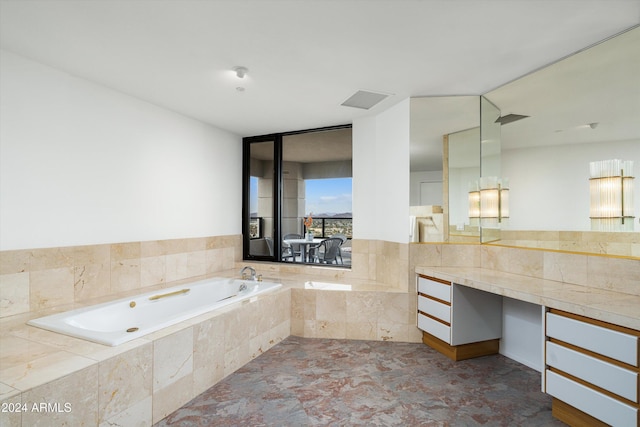 bathroom with a relaxing tiled tub and vanity