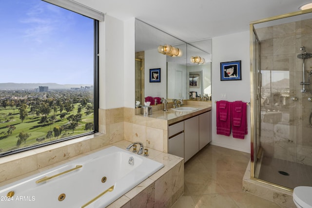 bathroom featuring shower with separate bathtub, vanity, and tile patterned floors