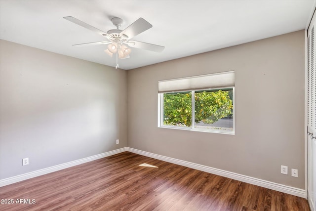 empty room with hardwood / wood-style flooring and ceiling fan