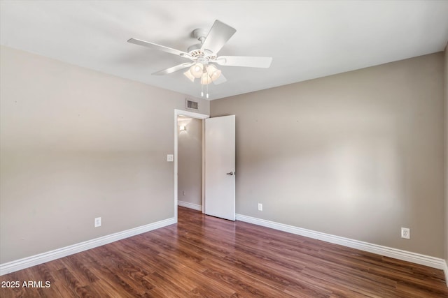 empty room with dark hardwood / wood-style floors and ceiling fan