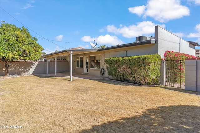 back of house featuring a yard and a patio area