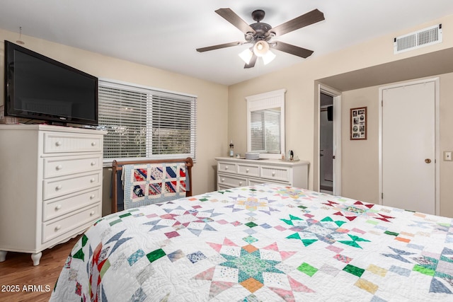 9826 W Emberwood Dr, Sun City, AZ 85351 - bedroom featuring visible vents, wood finished floors, and a ceiling fan