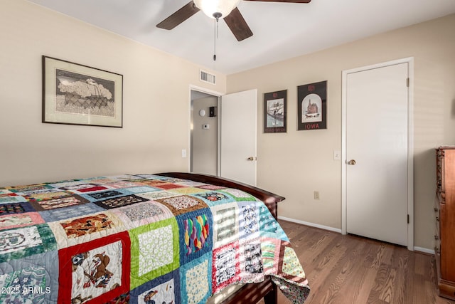 9826 W Emberwood Dr, Sun City, AZ 85351 - bedroom featuring ceiling fan, visible vents, baseboards, and wood finished floors