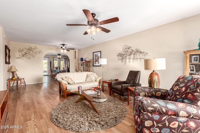 9826 W Emberwood Dr, Sun City, AZ 85351 - living room with ceiling fan, arched walkways, and wood finished floors