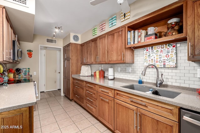 9826 W Emberwood Dr, Sun City, AZ 85351 - kitchen featuring visible vents, backsplash, appliances with stainless steel finishes, brown cabinetry, and a sink