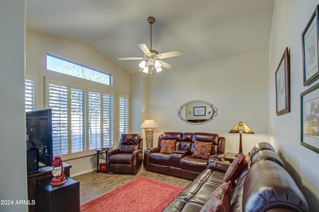 living room with ceiling fan, wood-type flooring, and vaulted ceiling