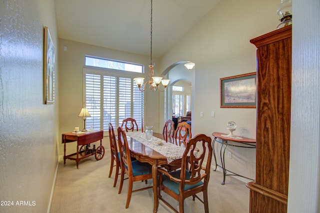 carpeted dining space with lofted ceiling and an inviting chandelier