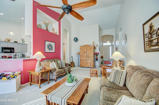 living room with light colored carpet and ceiling fan