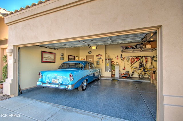 garage with a garage door opener and strapped water heater