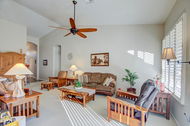 carpeted living room with high vaulted ceiling and ceiling fan